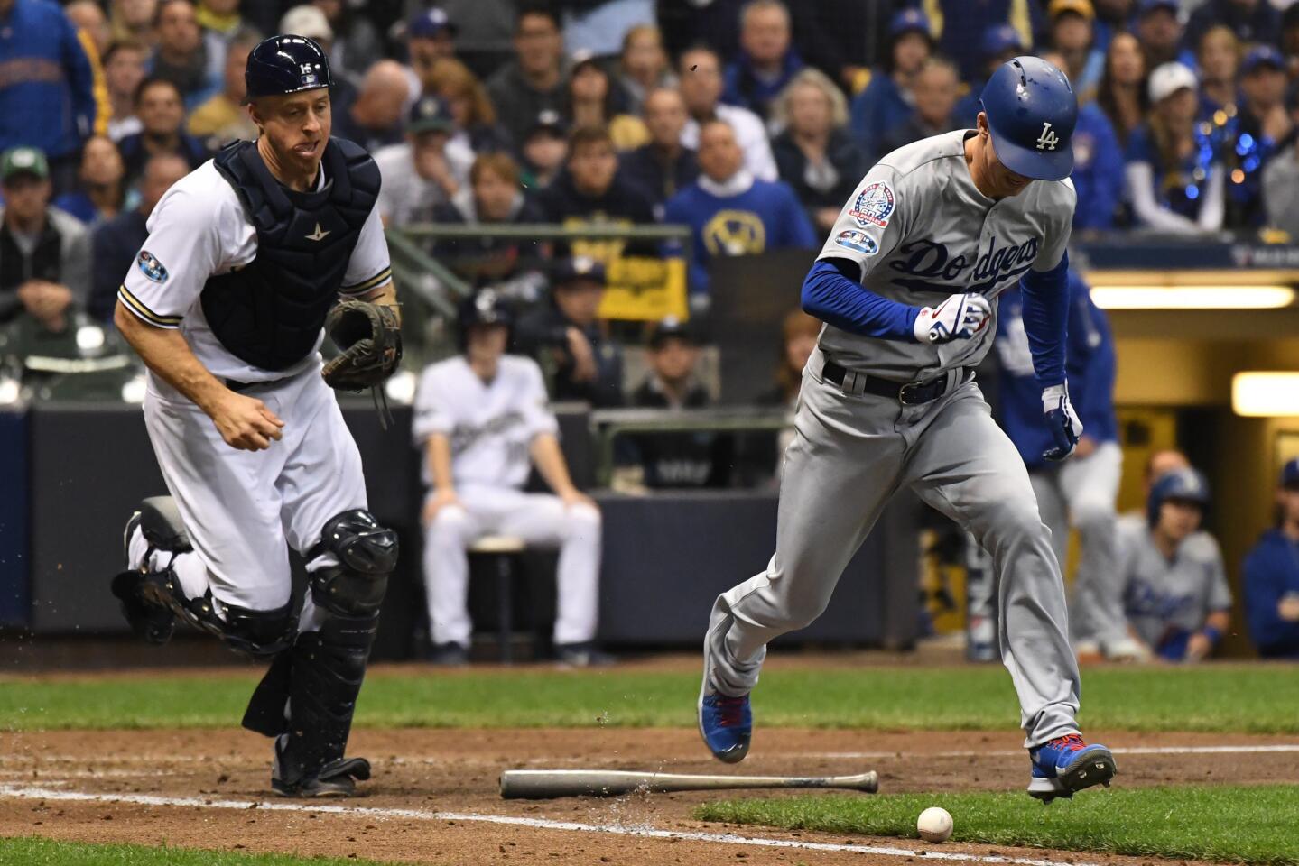 Dodgers Walker Buehler lays down a bunt as Brewers catcher Erik Kratz looks on in the 5th inning.