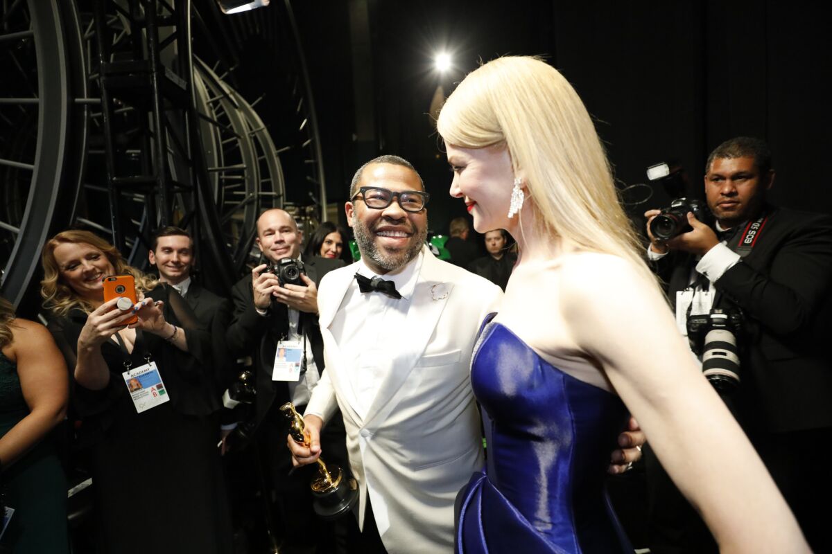 Jordan Peele, who won the Oscar for original screenplay, with presenter Nicole Kidman backstage.