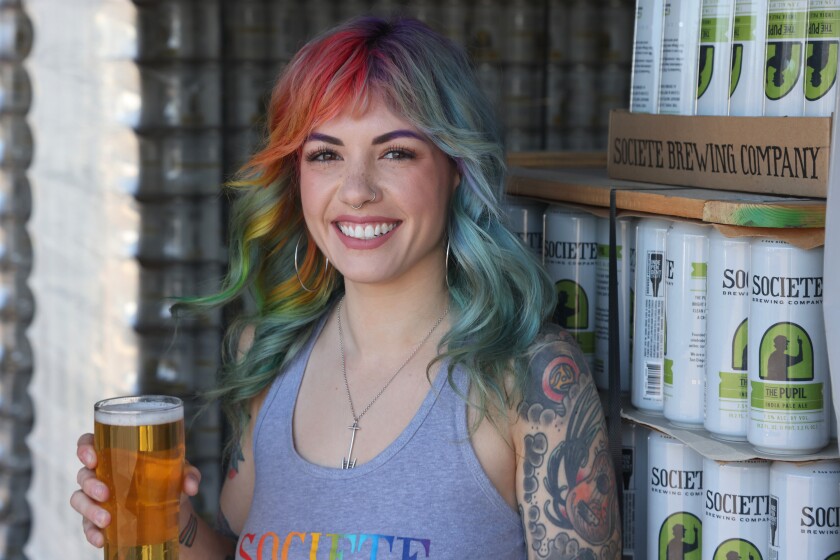 Brewer influencer Megan Stone poses for photos at Societe Brewing 
