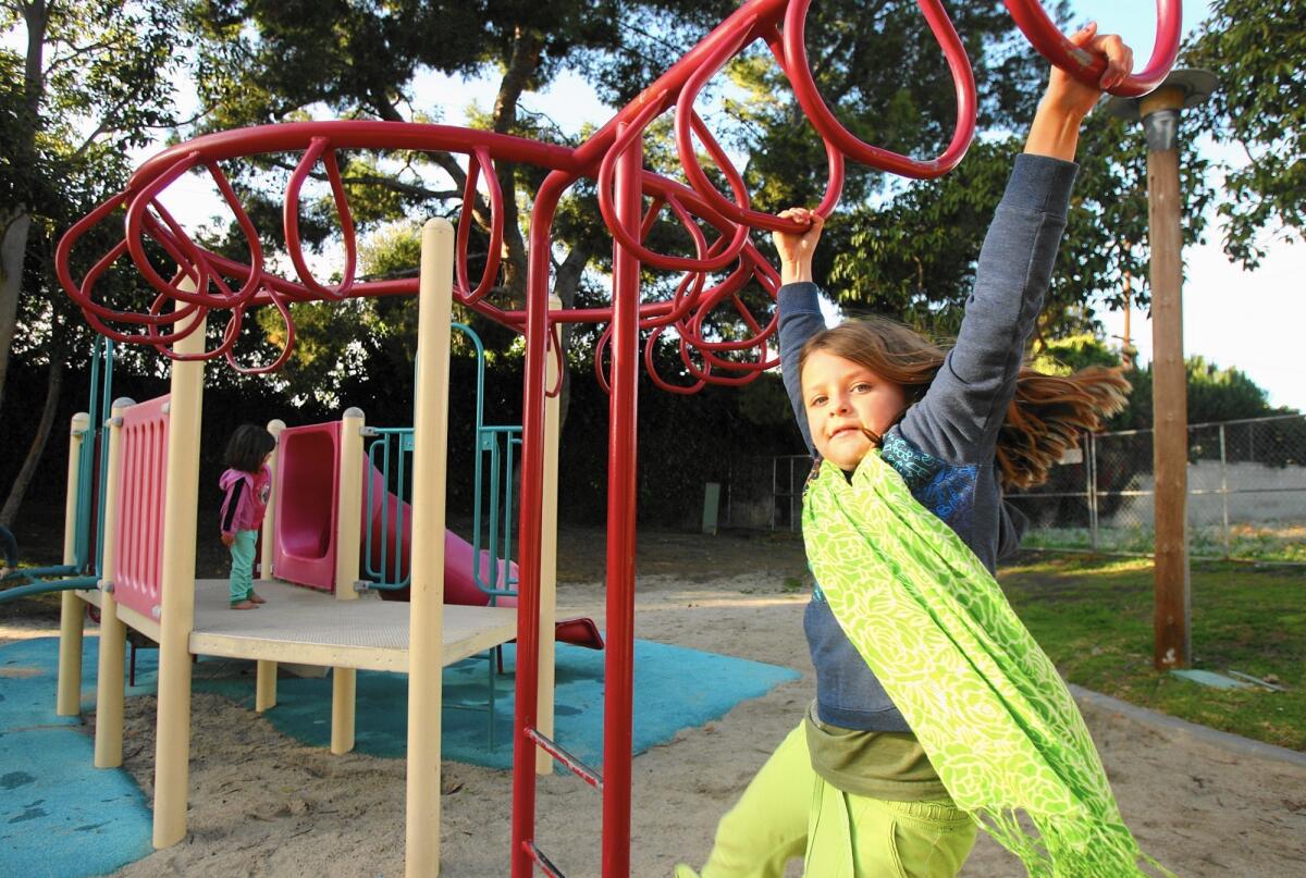 Children play at Brentwood Park in Costa Mesa, where the city of Costa Mesa has stepped up patrols and is looking at installing additional lighting after nearby residents raised concerns about loiterers.