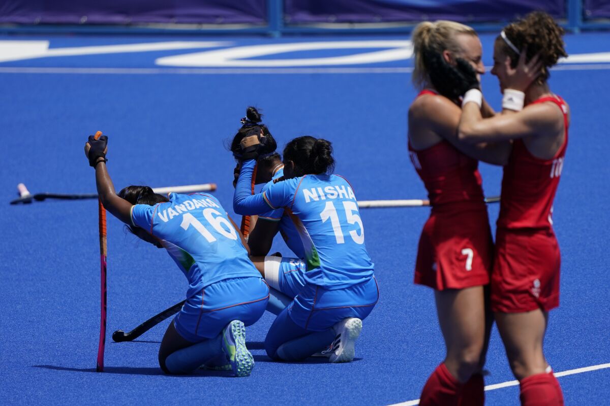 India's Vandana Katariya (16) and India's Nisha (15) kneel on the field after losing their women's field hockey bronze medal match against Britain at the 2020 Summer Olympics in Tokyo. (AP Photo/John Minchillo, File)
