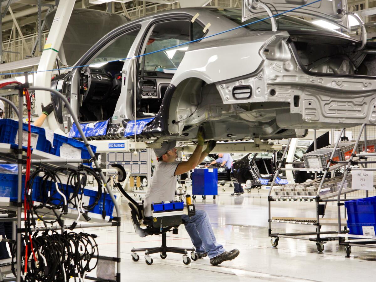 An employee works on a Passat sedan at the Volkswagen plant in Chattanooga, Tenn. Workers at the plant voted against representation by the United Auto Workers union.