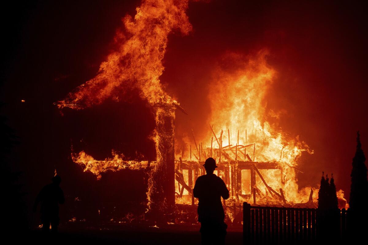 A home burns as the Camp fire rages through Paradise, Calif., in 2018.