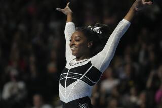 Simone Biles reacts after performing in the floor exercise at the U.S. Classic.