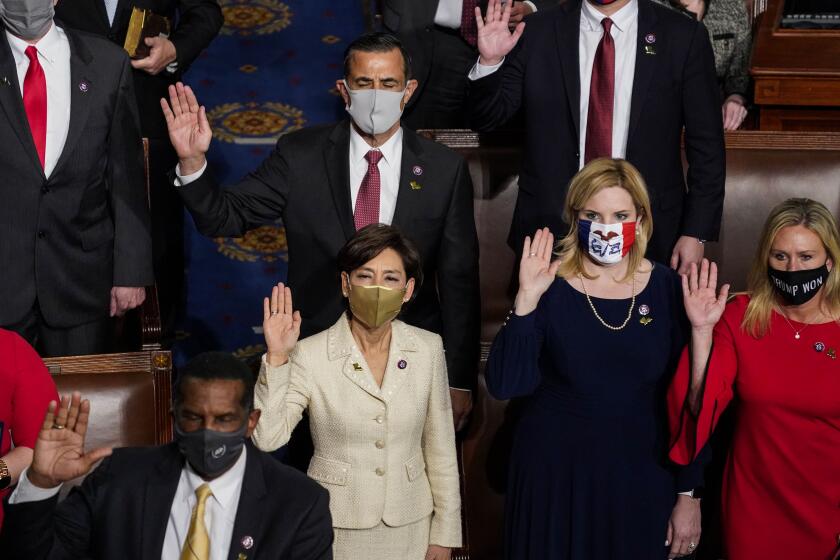 WASHINGTON, DC - JANUARY 03: Congresswoman Young Kim (D-CA) center, with other members of congress are sworn in during the first session of the 117th Congress in the House of Representatives at the U.S. Capitol Building on Sunday, Jan. 3, 2021 in Washington, DC. (Kent Nishimura / Los Angeles Times)