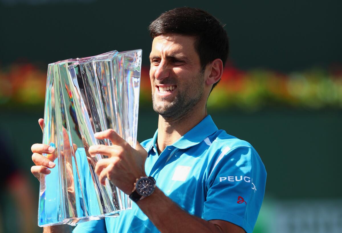 Novak Djokovic holds up the trophy after his win over Milos Raonic in the championship match of the BNP Paribas Open at Indian Wells on March 20.