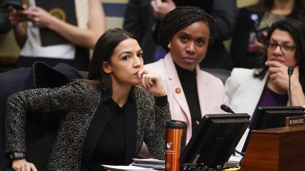 House Oversight and Reform Committee members, from left, Rep. Alexandria Ocasio-Cortez (D-N.Y.), Rep. Ayanna Pressley (D-Mass.) and Rep. Rashida Tlaib (D-Mich.), listen during a committee hearing on Capitol Hill on Feb. 26.