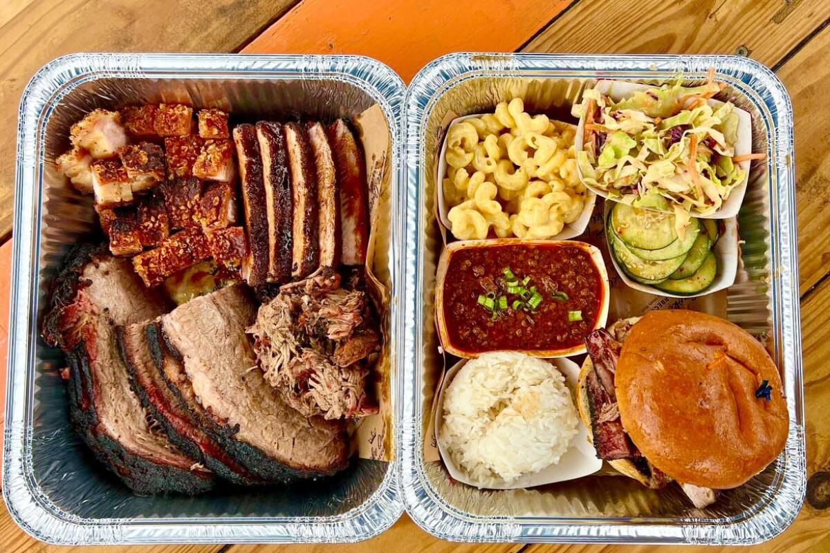 A tray of barbecued meats and sides from Smoke Queen BBQ.