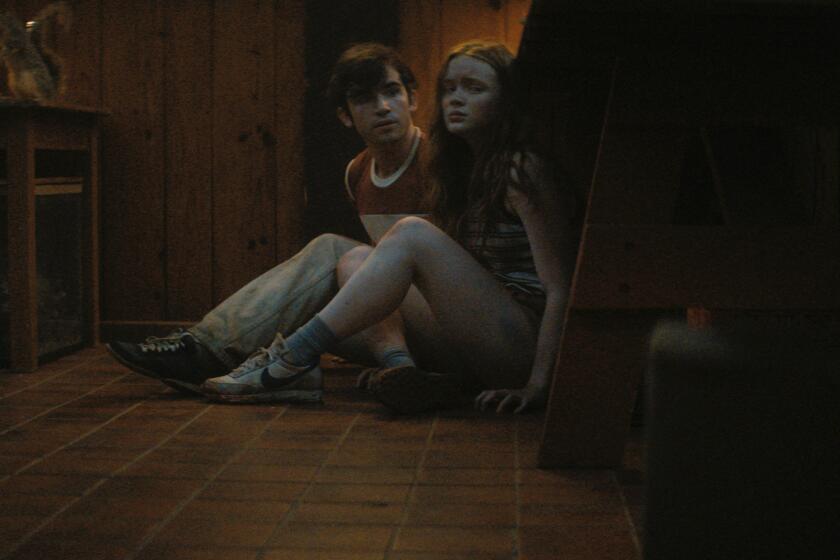 Ted Sutherland (l) as Nick and Sadie Sink (r) as Ziggy in "Fear Street Part 2: 1978"