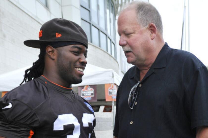 Former Cleveland Browns president Mike Holmgren, right, talks with running back Trent Richardson at training camp this summer. Richardson was traded to the Indianapolis Colts this week.