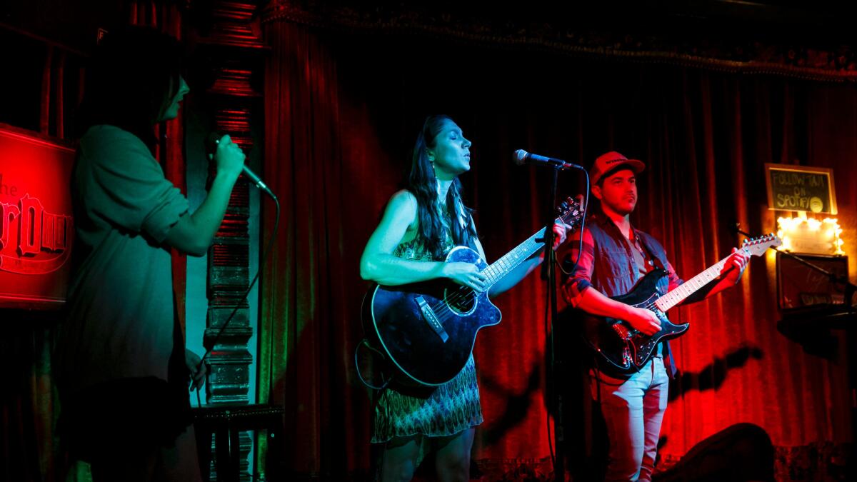 Jenny Skiffington, left, Laura Brunkala and Dustin Green from the band Broken Arrows, perform at The Other Door,