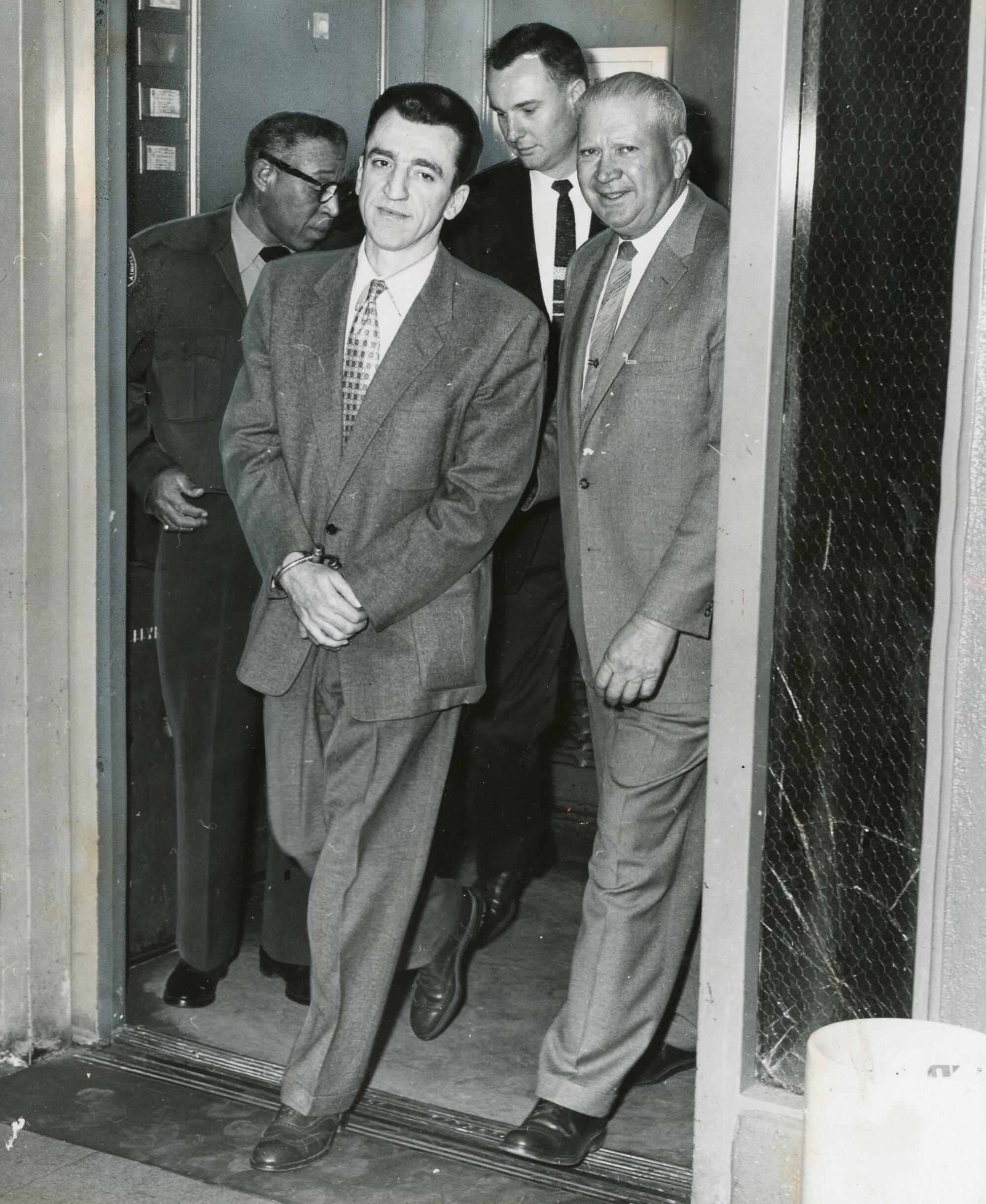 Caryl Chessman is escorted back to his death row cell in San Quentin.