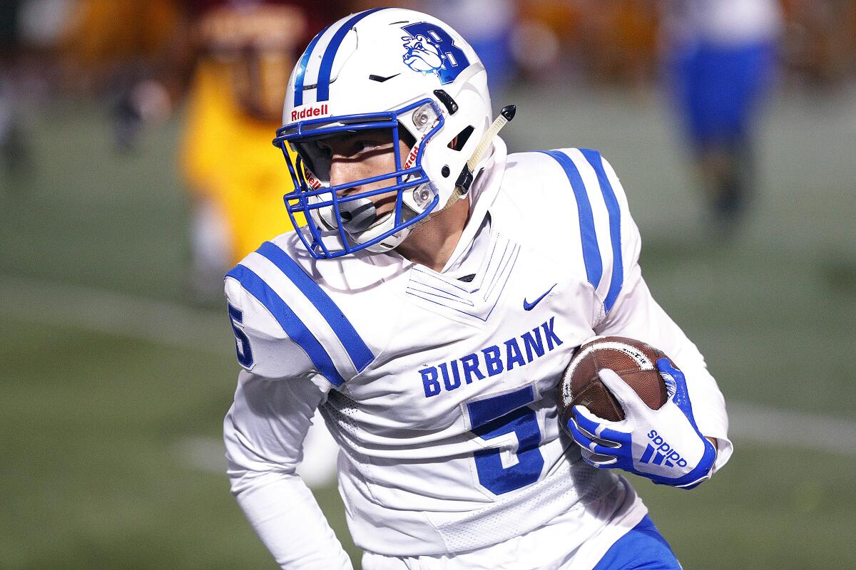 Burbank's Ben Burnham catches the ball and runs for the first touchdown of the game against Arcadia in a Pacific League football opener at Arcadia High School on Thursday, September 19, 2019.