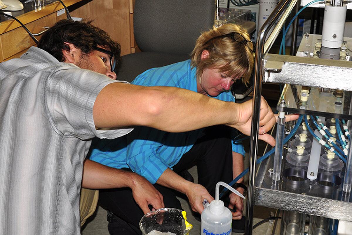 Microbial ecologists Bill Orsi now of Maryland University and Virginia Edgcomb of Woods Hole Oceanographic Institution work on a deep-sea robotic incubator in 2013.