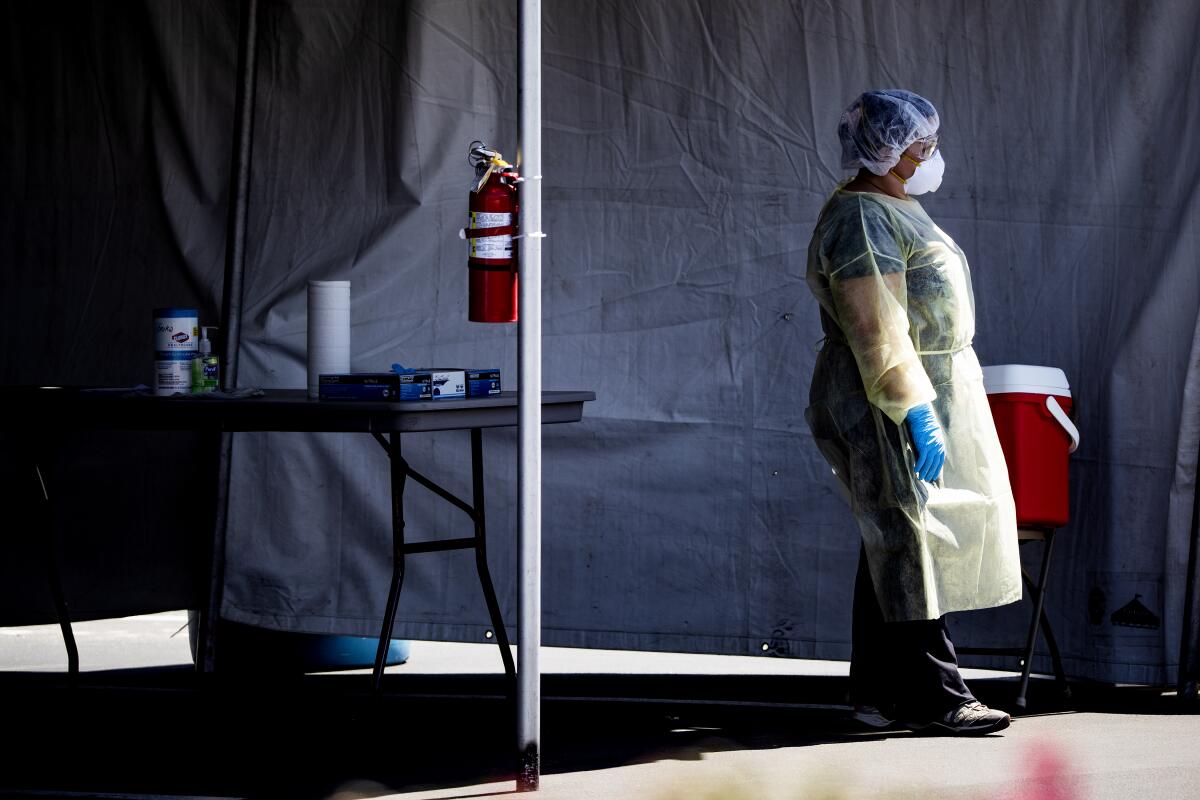 A nurse takes a break at a drive-though testing facility for Coachella Valley residents.