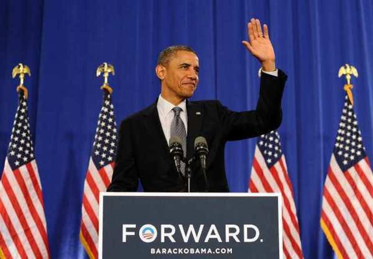 President Obama waves at supporters before speaking on the economy during a campaign event at the Cuyahoga Community College in Cleveland, Ohio.