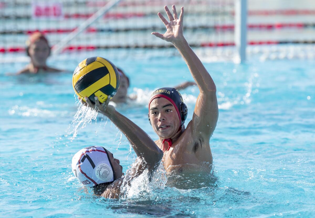 Estancia's Tyler Humphries attempts to block a shot from Lakewood's Anon Ellis.