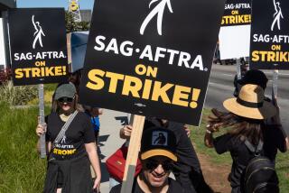 SAG-AFTRA members picket in Los Angeles.