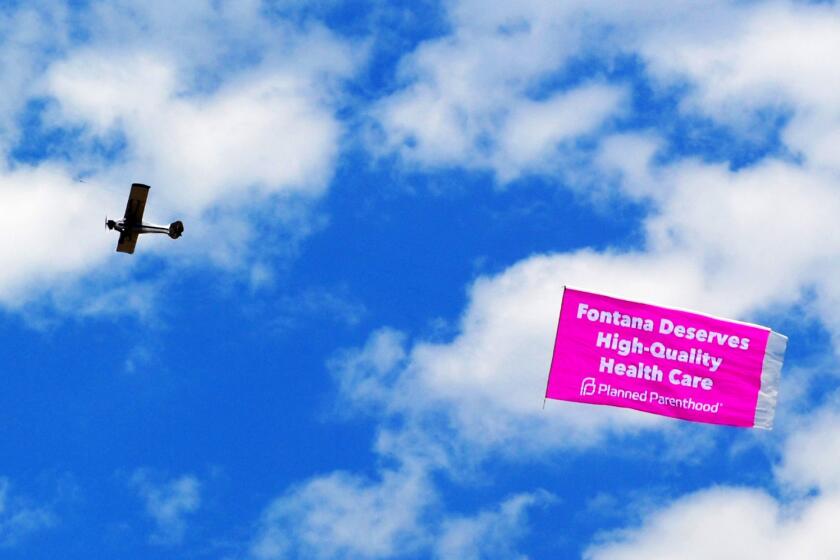 A plane flies over Fontana City Hall in July after the city council blocked the construction of a Planned Parenthood clinic.