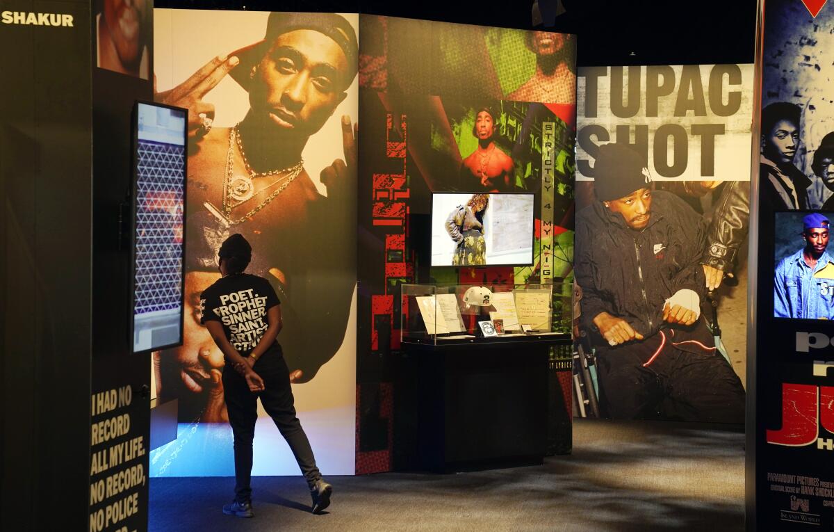 A visitor observes a display of late hip-hop artist Tupac Shakur.