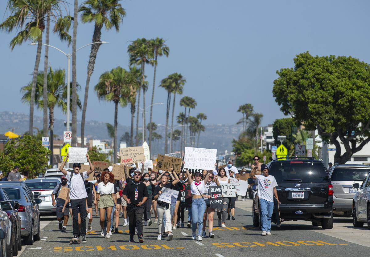 Protesters walk along Balboa Boulevard in Newport Beach during a peaceful protest June 3 over the killing of George Floyd.