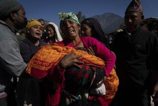 A woman holds the lifeless body of her grand child killed in earthquake in Jajarkot district, northwestern Nepal, Sunday, Nov. 5, 2023. Friday night’s earthquake in the district killed more than hundred people while more than fifty were killed in the neighboring Rukum district, officials said. (AP Photo/Niranjan Shrestha)