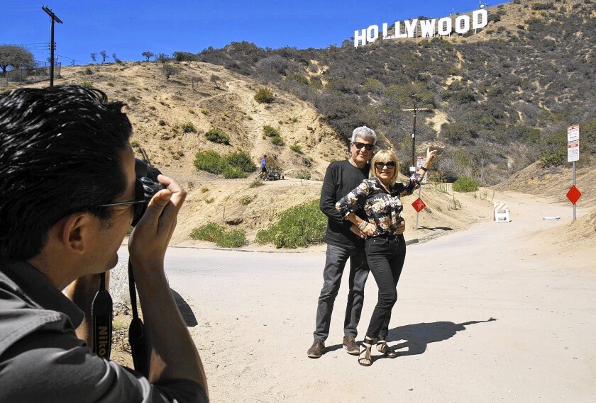 Silvestre Llobet and his wife, Elena Domenech, visiting from Spain, are photographed by their son, Alejandro Llobet, under the Hollywood sign.