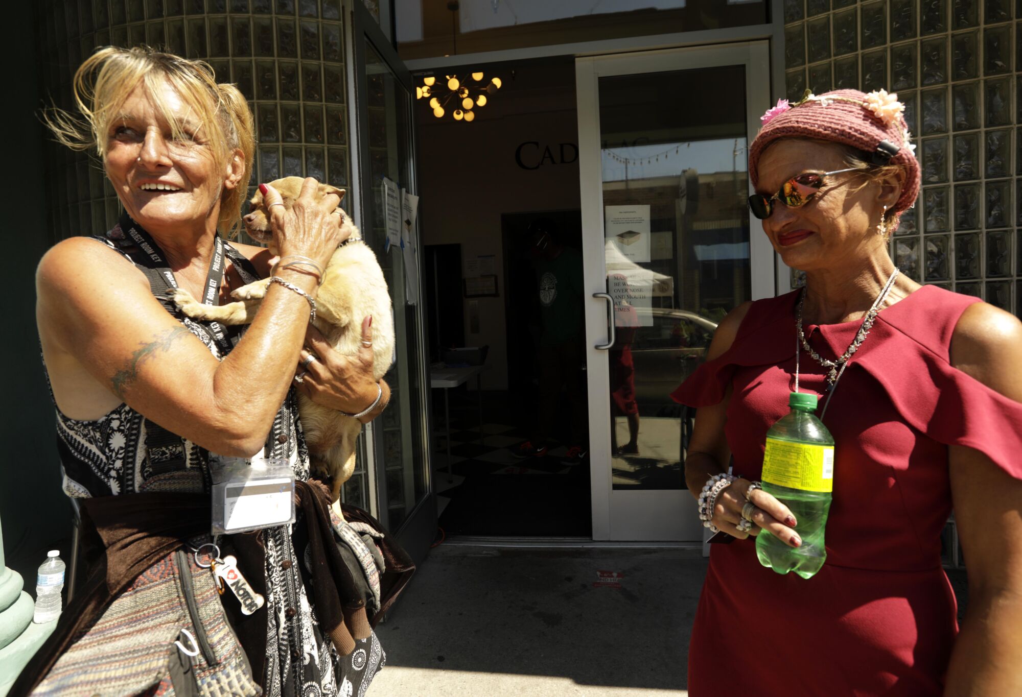 Teresa Robles, 63, left, her dog Notcho, and Dixie Moore, 47, who were all living homeless along Ocean Front Walk