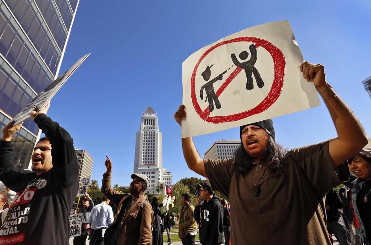 Victor Africa, right, and others protest at LAPD headquarters March 3 after a march from the skid row site where a homeless man was killed by LAPD officers.