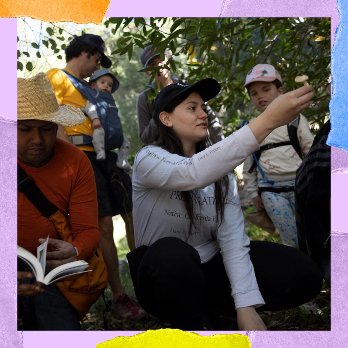 A woman holds up a mushroom, surrounded by a crowd.