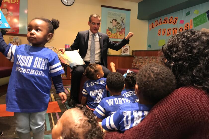 Mayor Eric Garcetti reads to children at the Central Library