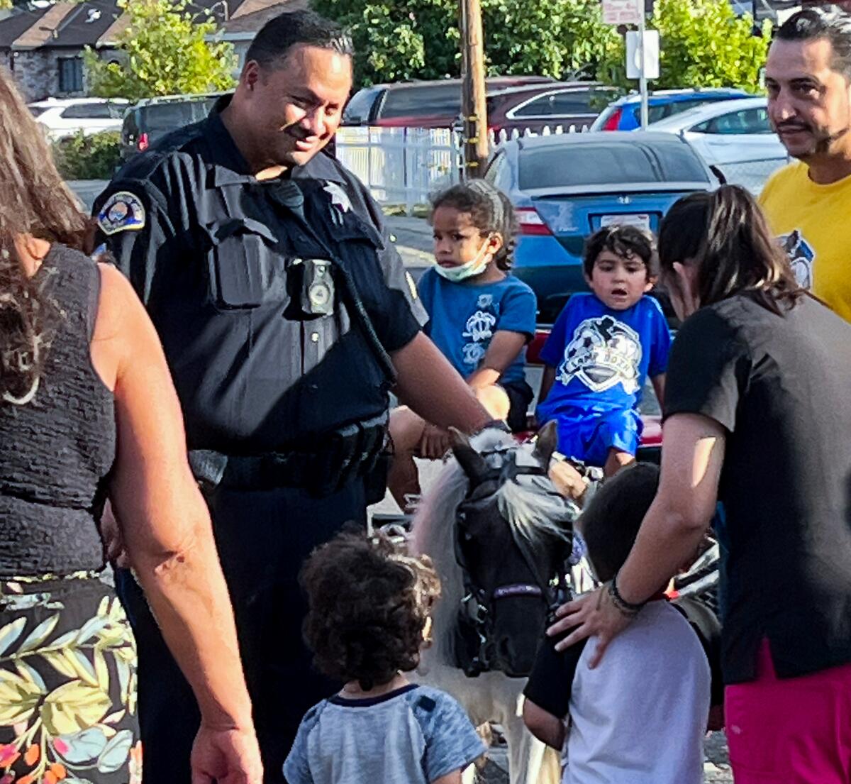 East Palo Alto Sergeant Matafanua Lualemaga interacts with community members during National Night Out in 2022.