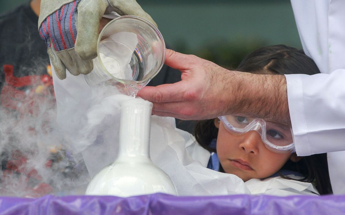 Andromeda Obenshain, 6, helps Radical Rob, of the Mad Science Show.