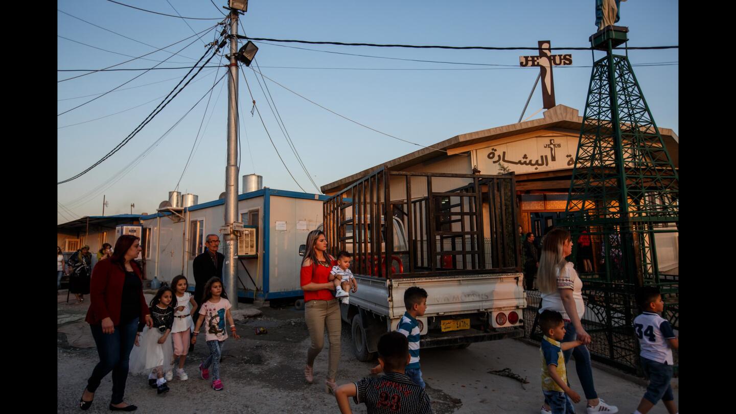 Christian refugees arrive for Holy Saturday church services, on the eve of Easter at Al-Bashara Church at a Christian refugee camp in Irbil, Iraq, on April 15, 2017. There are more than 100,000 Christian refugees in the Christian township of Ainkawa who have been driven out of their homes in Qaraqosh, Karemlash and Bartella since Islamic State attacked Christian communities northern Iraq in 2014.