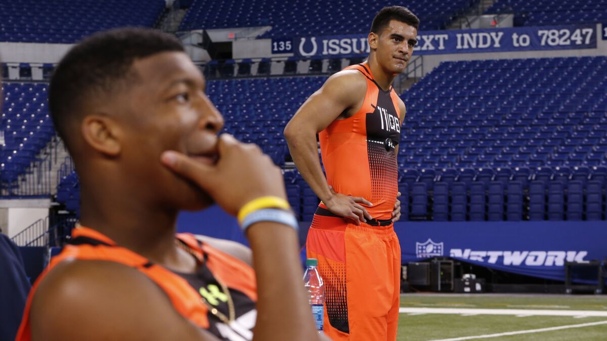 Oregon quarterback Marcus Mariota, right, stands next to Florida State quarterback Jameis Winston before taking part in a drill at the NFL Scouting Combine in Indianapolis on Feb. 21.