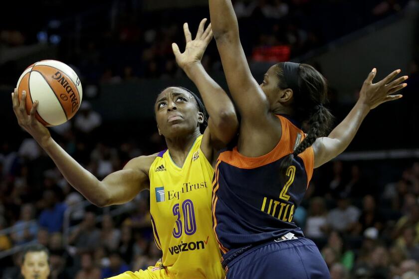 Sparks forward Nneka Ogwumike, left, shoots over Sun forward Camille Little during the second half.