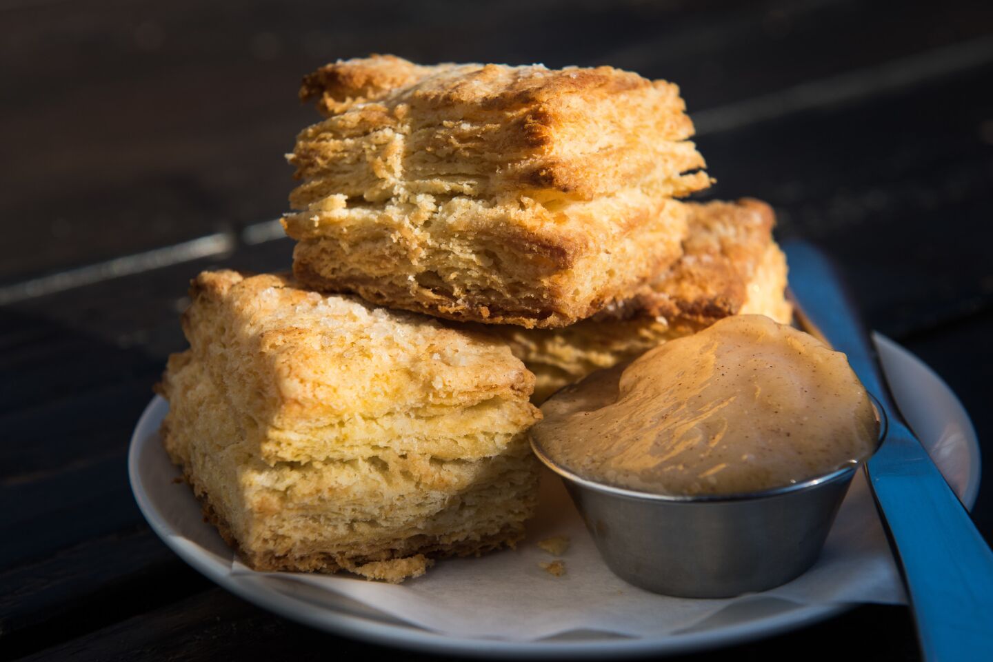 Flaky buttermilk biscuits with honey butter at Everson Royce Bar.