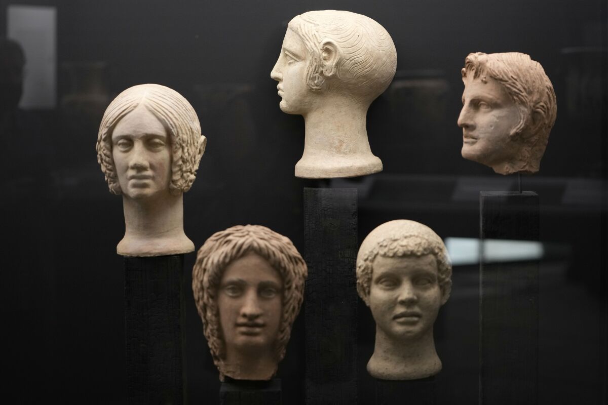 Votive terracotta heads and half-heads from the 3rd and 4th centuries B.C. are displayed in the new "Museum of Rescued Art" in Rome, Wednesday, June 15, 2022. Italy has been so successful in regaining ancient artworks and artifacts illegally exported from the country that it has now created a museum just for them, the Museum of Rescued Art, inaugurated on Wednesday in the cavernous Octagonal Hall of the ancient Baths of Diocletian. (AP Photo/Alessandra Tarantino)