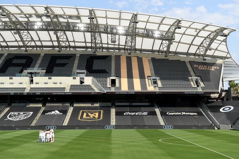 LOS ANGELES, CALIFORNIA AUGUST 22, 2020-Galaxy soccer players gather at an empty stadium before a game against LAFC at Banc of California in Los Angeles Saturday. (Wally Skalij/Los Angeles Times)