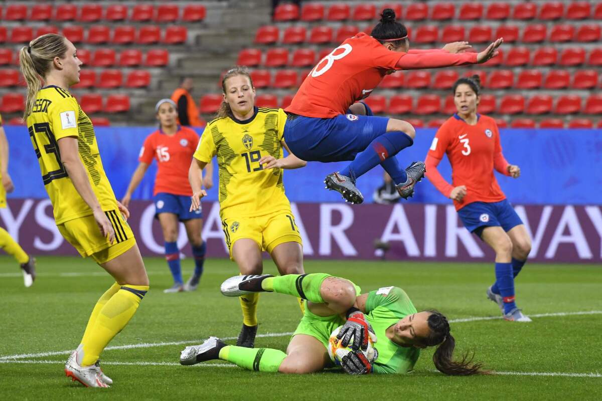 Chile midfielder Karen Araya jumps over goalkeeper Christiane Endler during a loss to Sweden in the Women's World Cup on Tuesday.