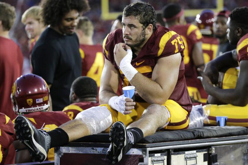 USC center Max Tuerk watches from the sideline during a game against Washington on Thursday.