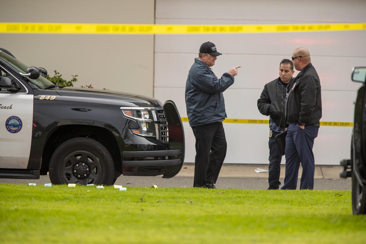 Huntington Beach Police personnel investigate the site of an officer-involved shooting in Sunset Beach on Monday.