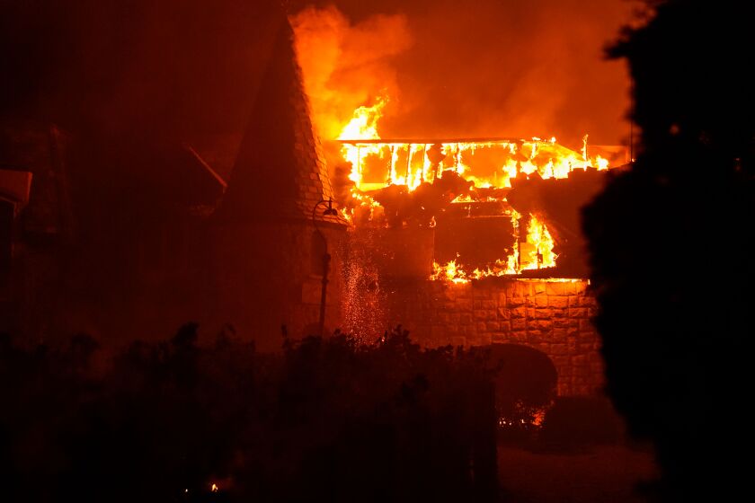 The Glass fire burns a distinctive building at the Chateau Boswell Winery on Sunday, northwest of St. Helena, Calif.