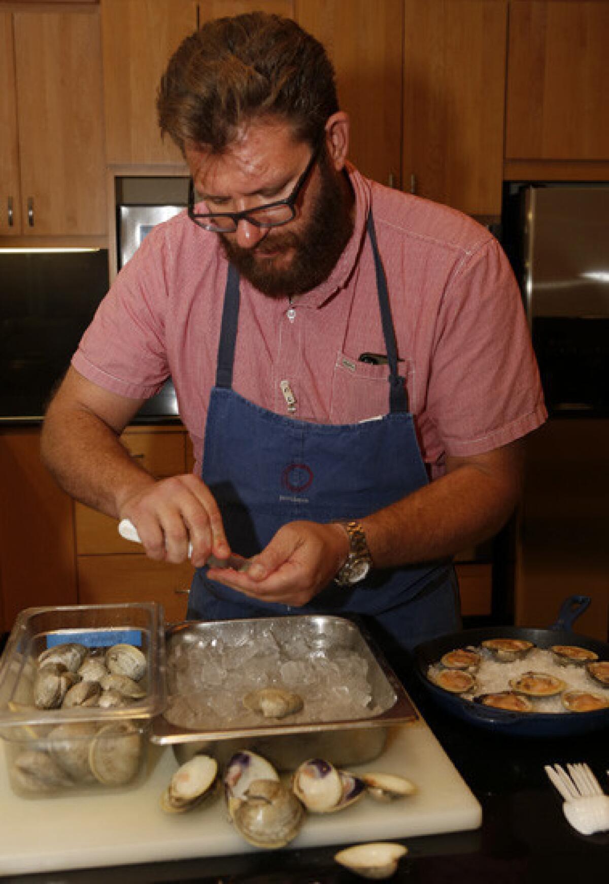 Chef Michael Cimarusti of Providence and Connie and Ted's restaurants shucks shellfish as he prepares three recipes: deviled oysters, oysters Rockefeller and broiled clams with herbed butter.