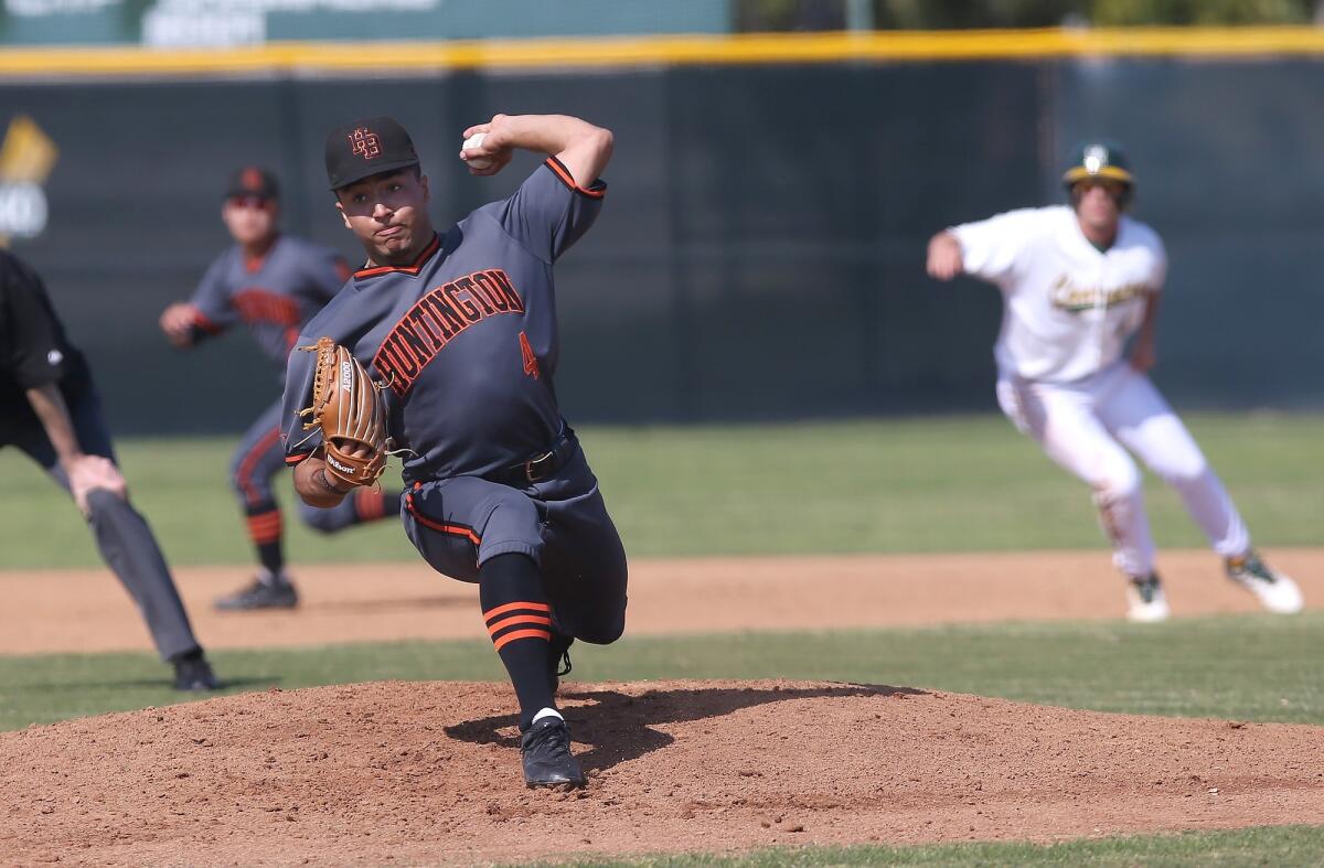 Huntington Beach High starter Edward Pelc throws a pitch during a Surf League game at Edison on Friday.