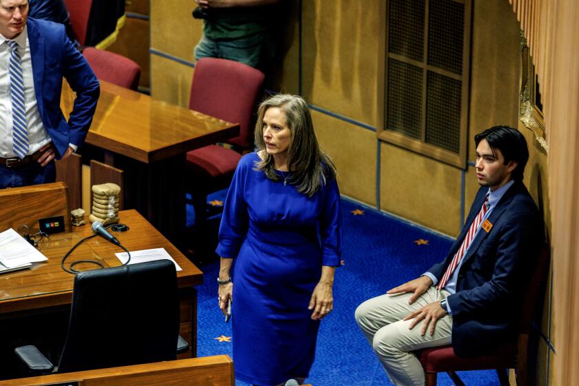 PHOENIX, AZ - APRIL 17, 2024: Arizona Sen. Shawnna Bolick walks in the senate chambers on April 17, 2024 in Phoenix, Arizona. She is married to Arizona Supreme Court Justice Clint Bolick who was part of the court's 4-seat majority that allowed enforcement of an 1864 law prohibiting abortions except when a mother's life was at risk. She voted to repeal it.(Gina Ferazzi / Los Angeles Times)