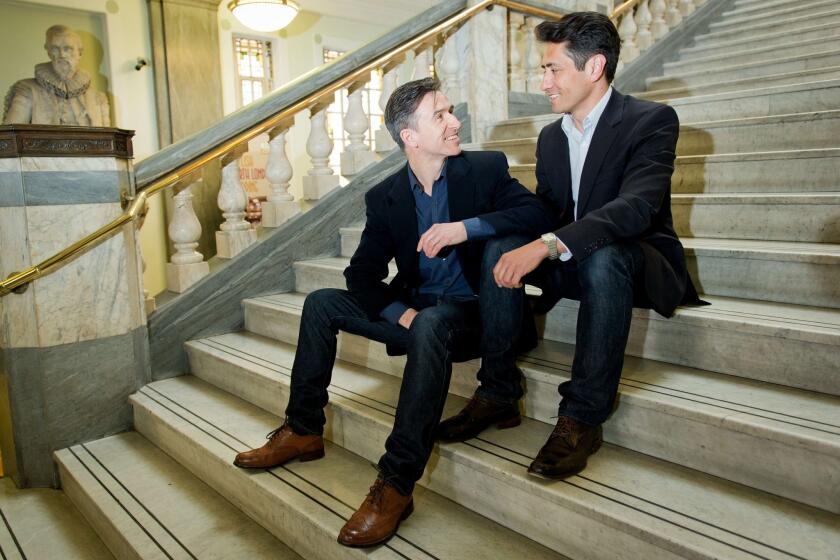 Peter McGraith, left, and David Cabreza pose for photographs at Islington Town Hall in north London. They plan to be one of the first same-sex couples in Britain to marry on Saturday.