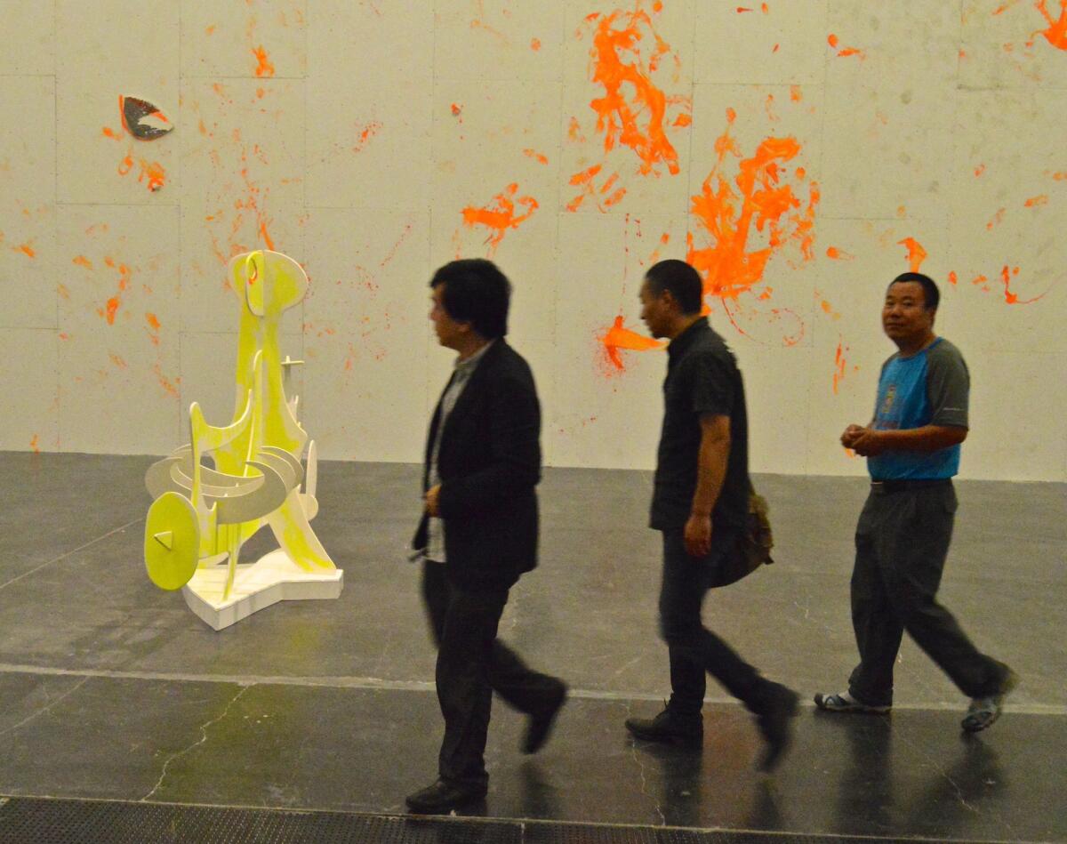 Visitors to the Ullens Center for Contemporary Art in Beijing approach a work by Aaron Curry.