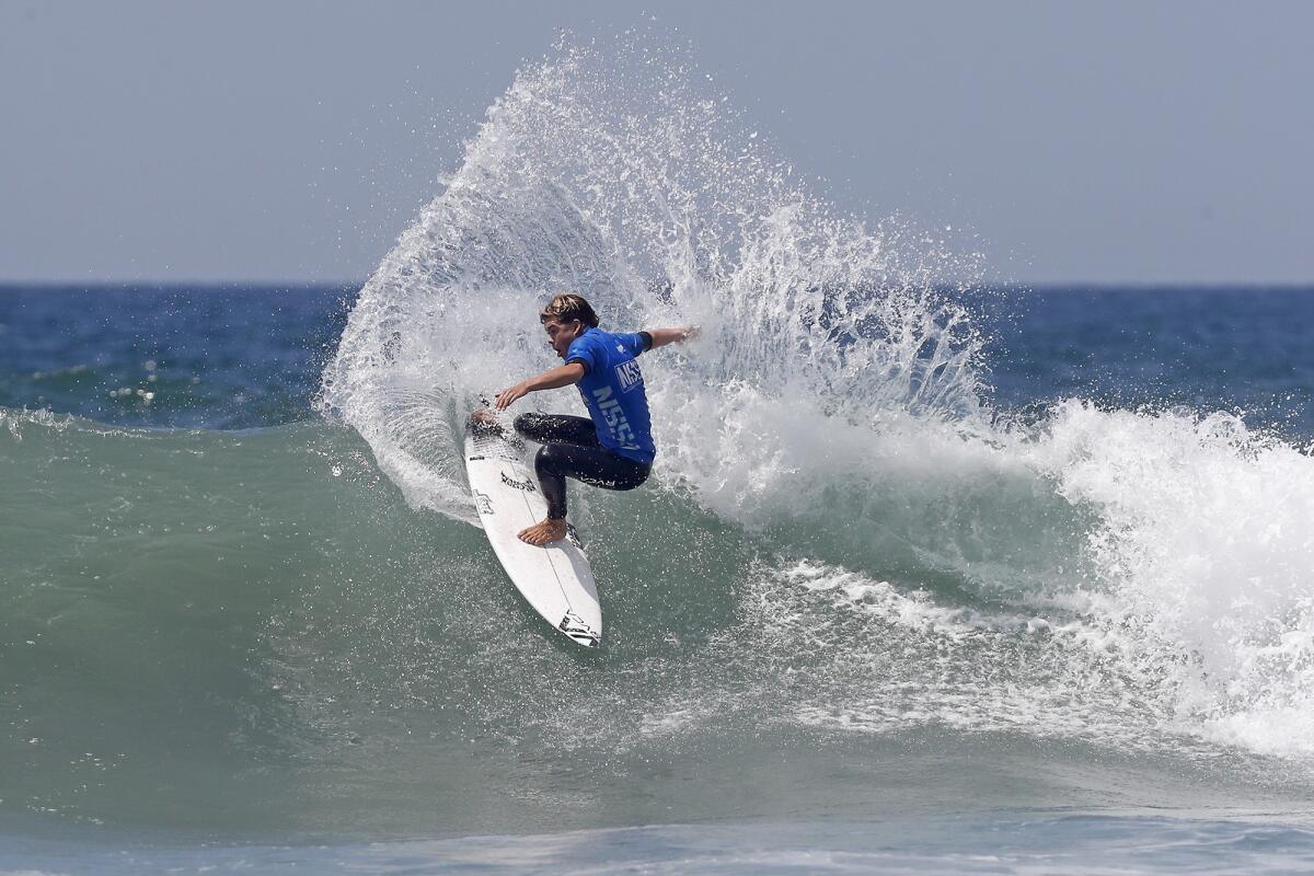 Taj Lindblad of San Clemente competes in the open men's final at the National Scholastic Surfing Assn. National Championships in Huntington Beach on Wednesday.