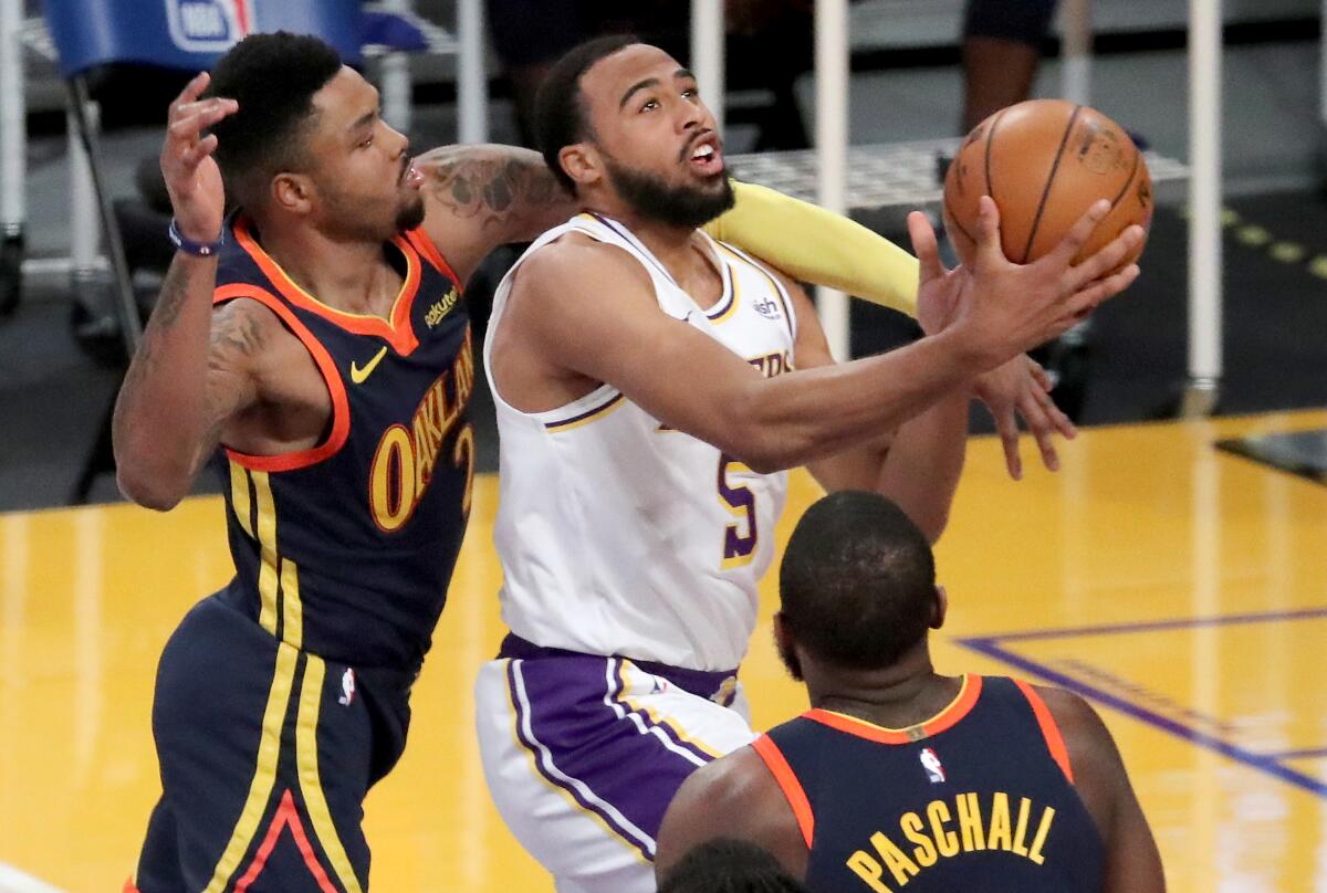 Lakers guard Talen Horton-Tucker is fouled by Golden State Warriors guard Kent Bazemore.